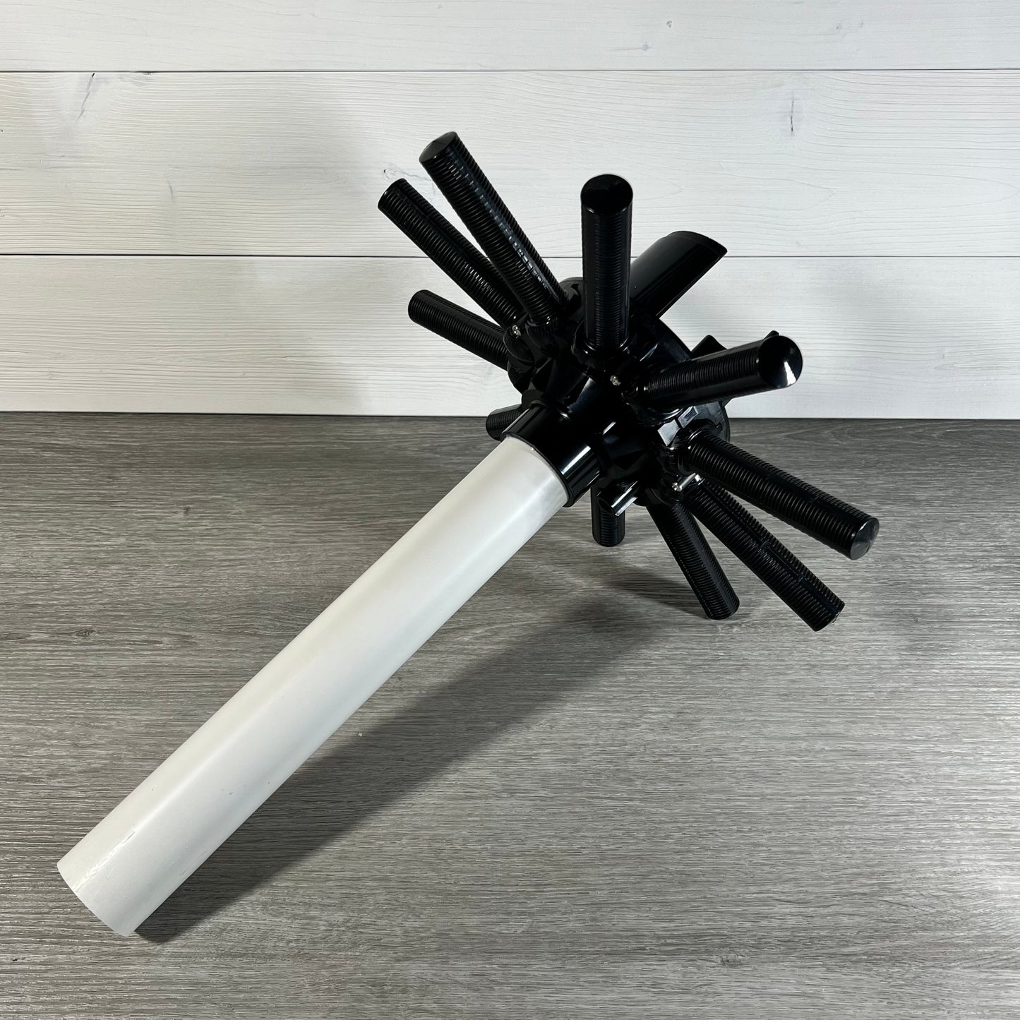 Lateral assembly with center pipe designed for Hayward filters, featuring durable black spokes and a white pipe extension.