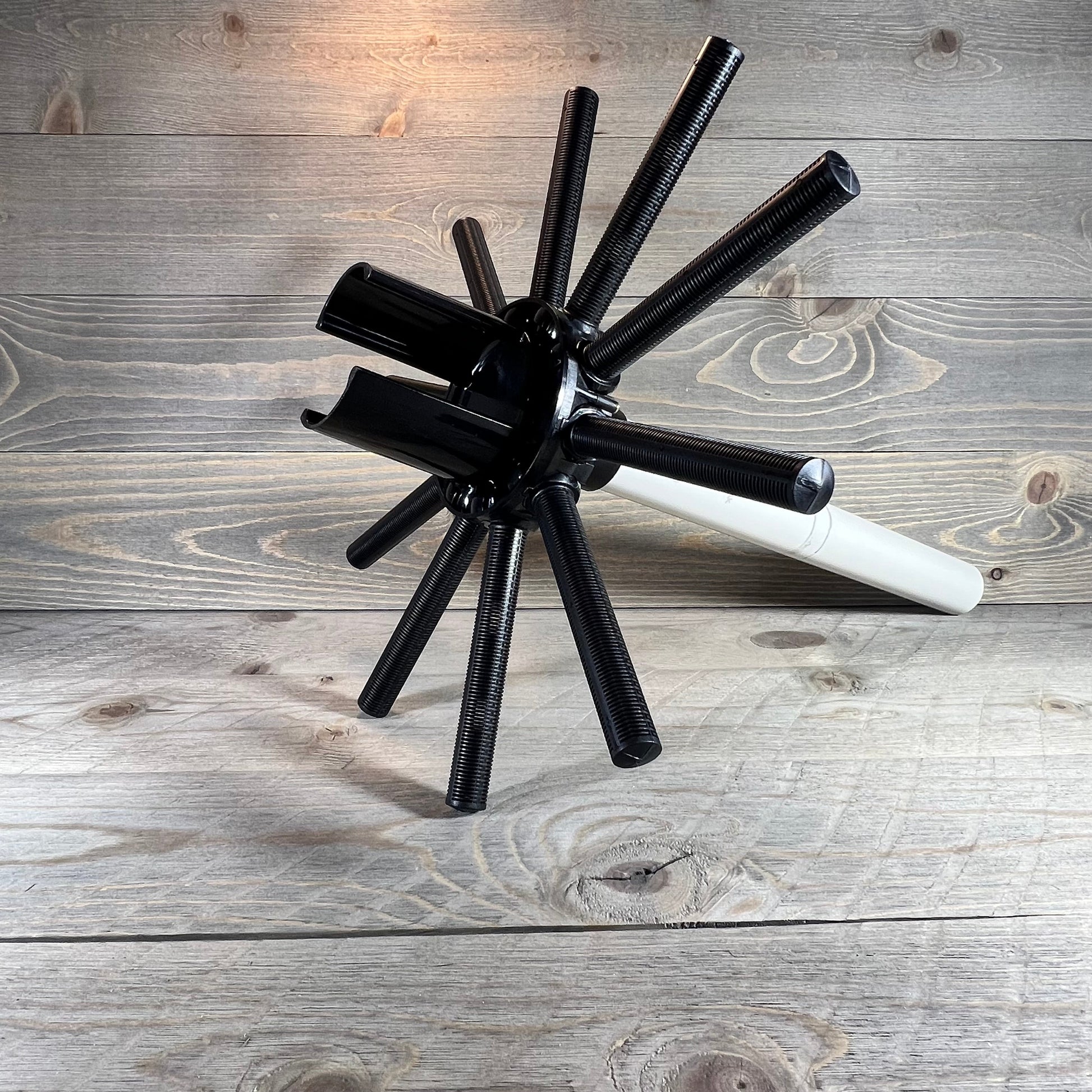 Lateral assembly with center pipe replacement for Hayward sand filter, featuring robust black arms on wood background.