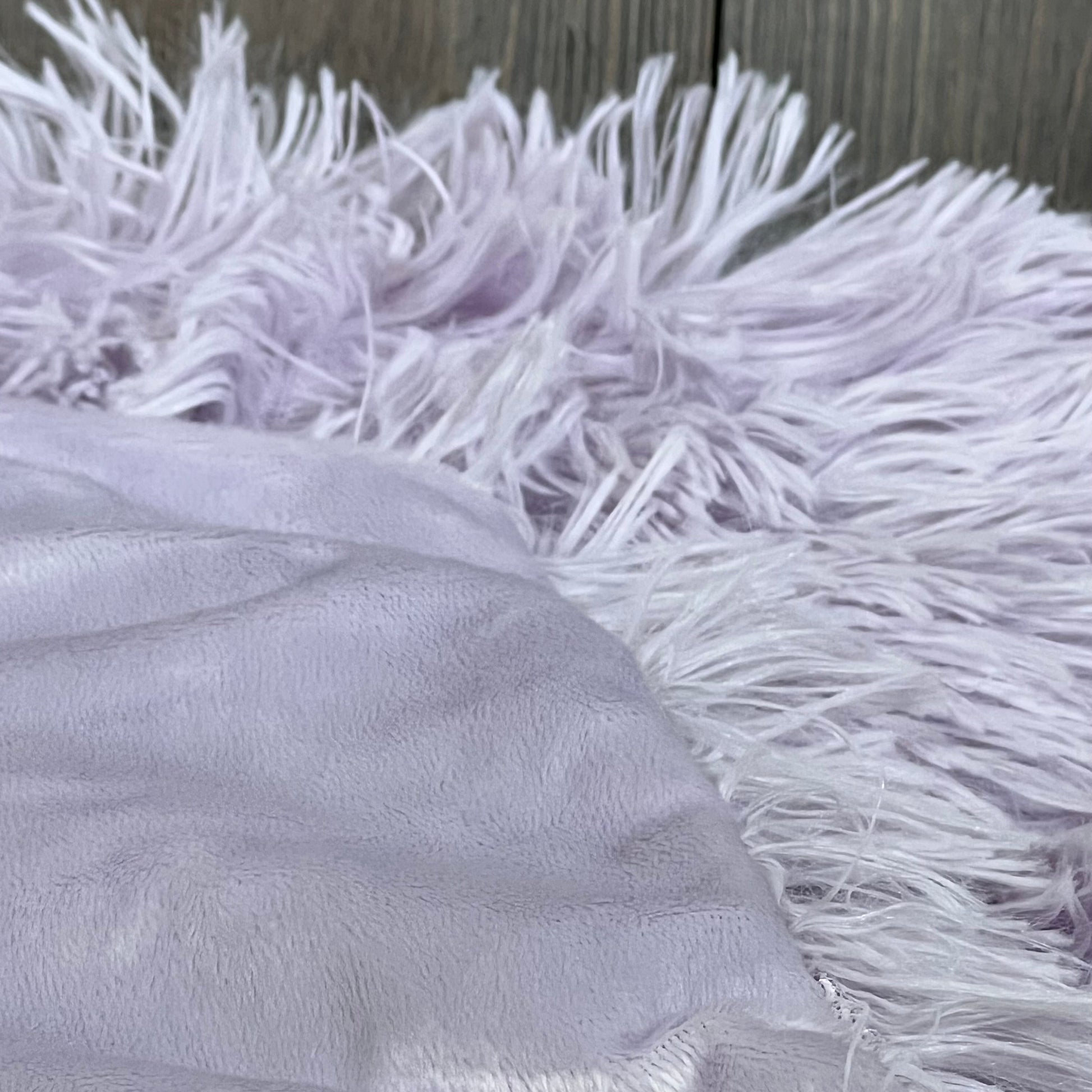 Lavender faux fur throw pillow cover with plush shaggy texture, perfect for cozy home decor.