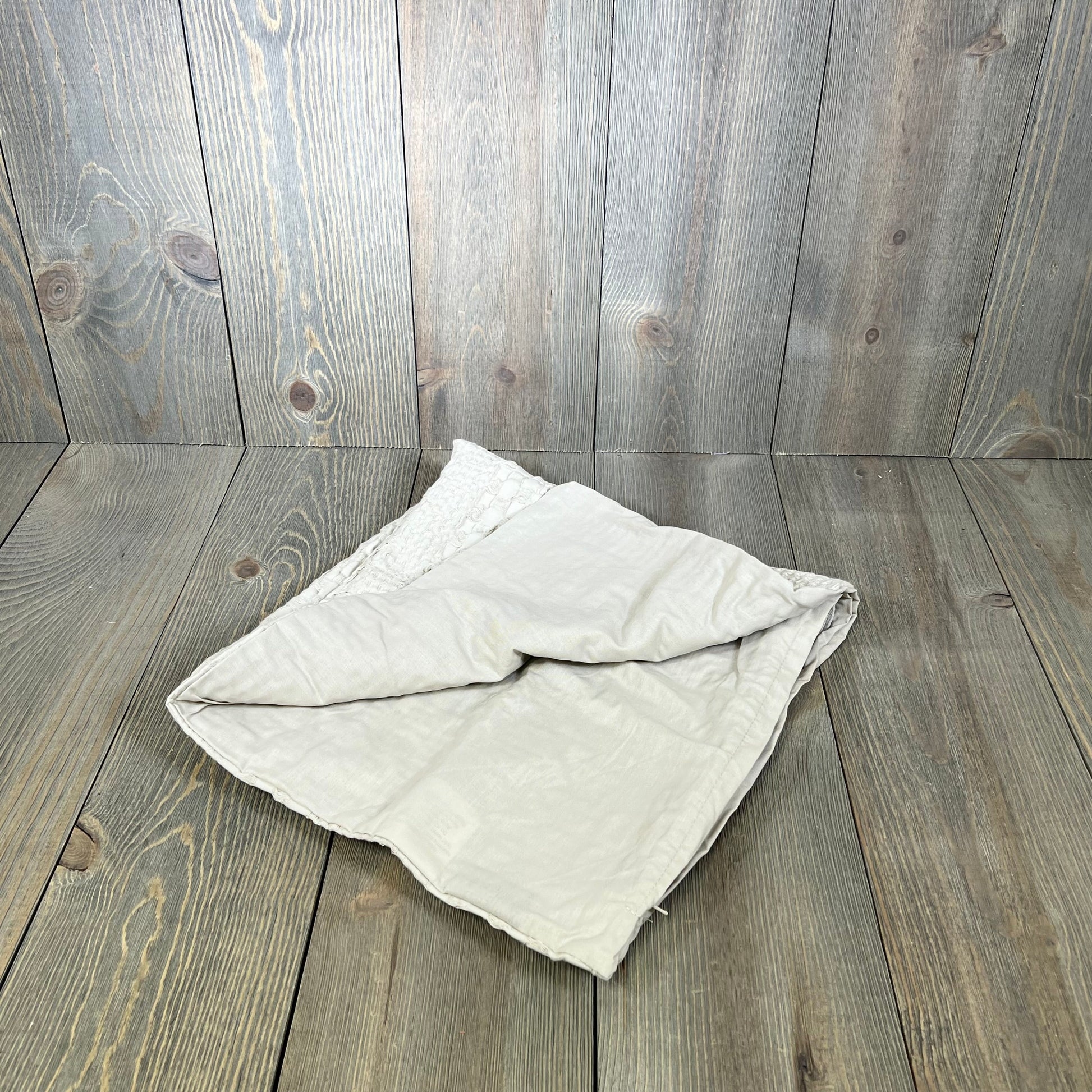 Elegant oatmeal cotton waffle weave Euro sham cover on rustic wooden background, showcasing luxury aesthetic design.