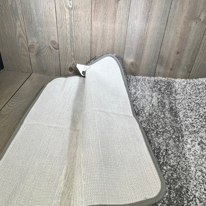 Non-slip grey OLANLY bathroom rug, showcasing plush shag and absorbent microfiber texture on a wooden floor.