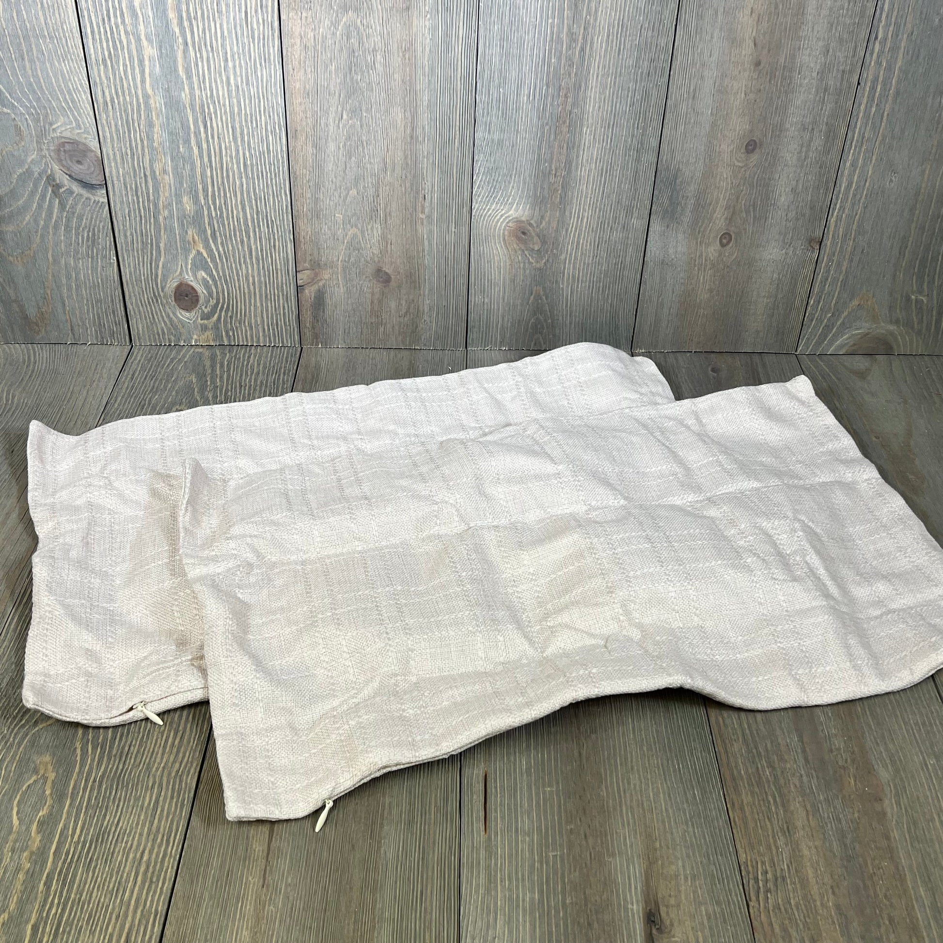 Light beige waterproof pillow covers with a checkered pattern, ideal for outdoor patio use, size 12x20 inches.