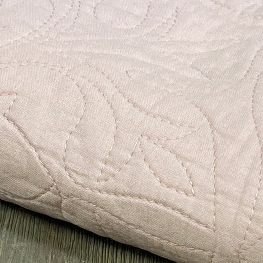 Dusty pink floral quilted pillow sham, 100% cotton, showcasing intricate stitching and soft texture.