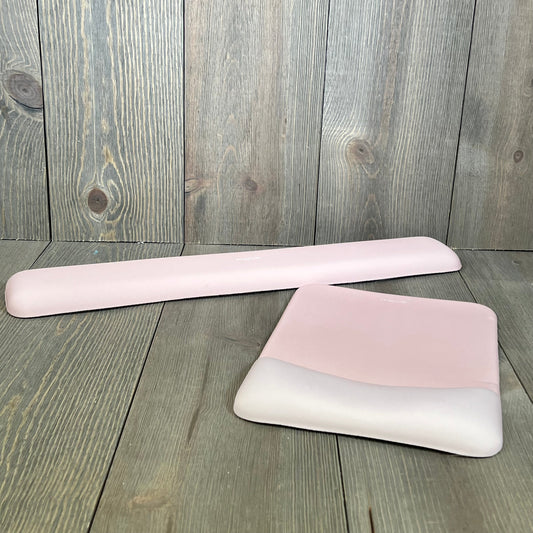 Ergonomic apricot wrist rest set with memory foam for mouse and keyboard, providing comfort and pain relief on wood surface.