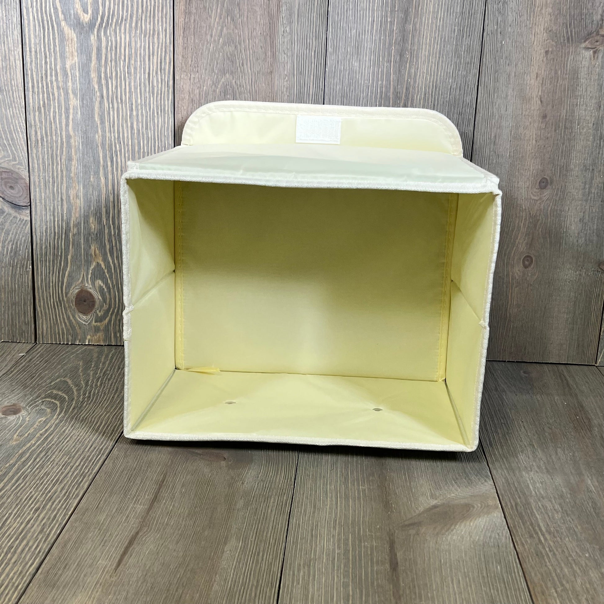 Green collapsible storage box with lid and faux leather handles, perfect for organizing closets and shelves.