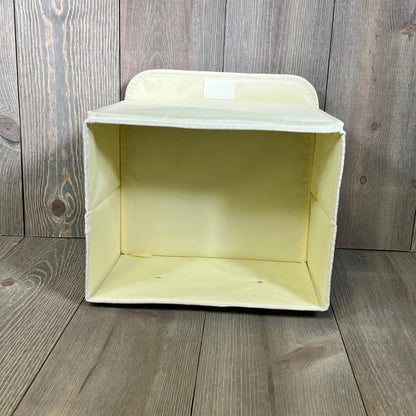 Green collapsible storage box with lid and faux leather handles, perfect for organizing closets and shelves.