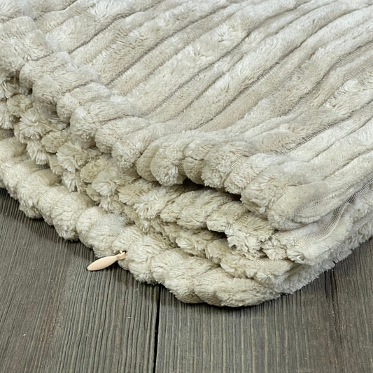 Creamy white velvet pillow cover with plush corduroy texture, folded on a wooden floor, 20x20 inch size, set of 2.