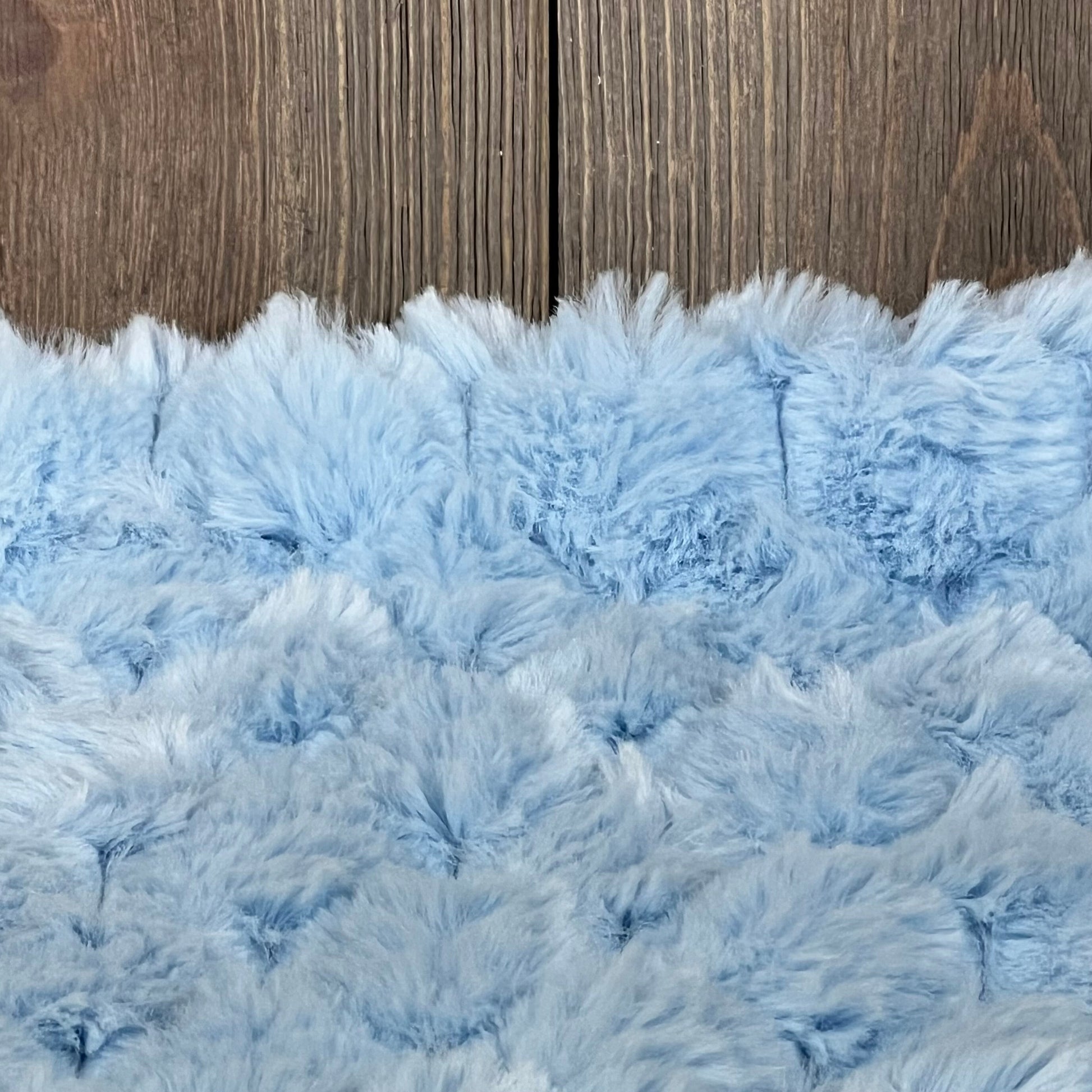 Light blue plush faux fur texture of MANDIOO decorative throw pillow cover, 18x18 inches, perfect for sofa or bed decor.