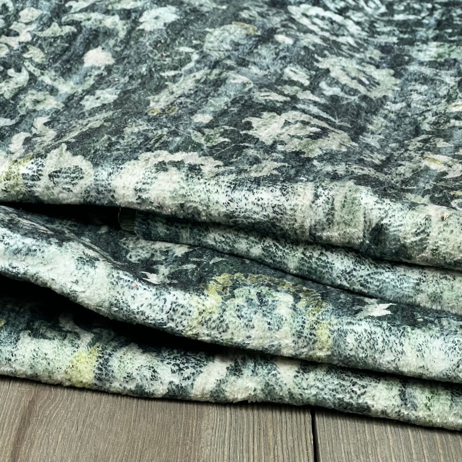Vintage floral runner in dark green, folded, showcasing soft faux wool texture for entryway or kitchen.