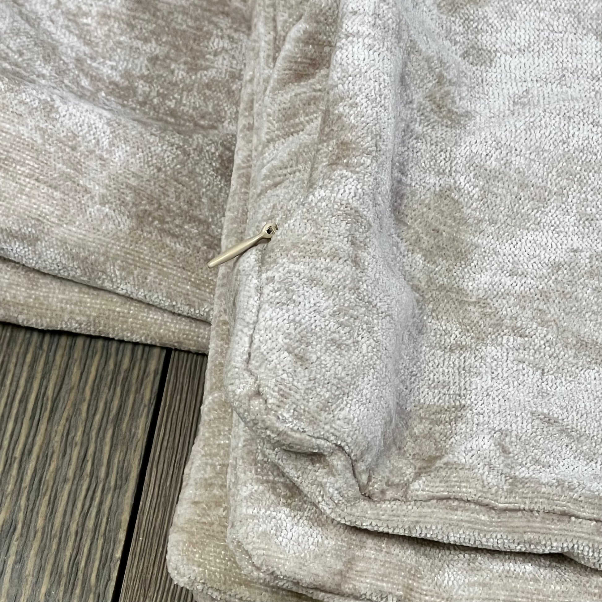 Soft chenille throw pillow covers in bleached sand with zipper detail, perfect for sofa or bed decor.
