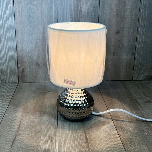 Mini hammered silver table lamp with white shade, perfect for modern decor and ambient lighting.
