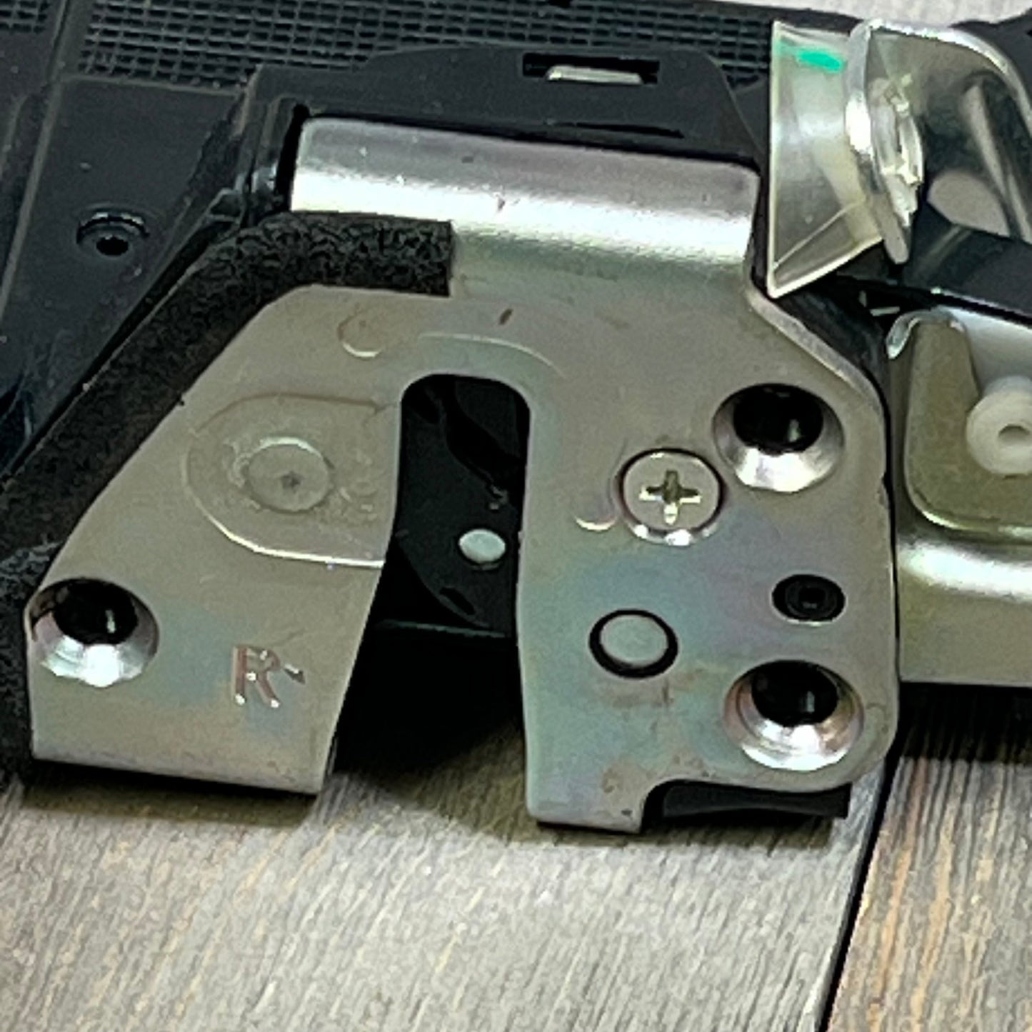 Close-up of SYERAL power door lock actuator, front right passenger side, metal latch for Toyota and Lexus models.