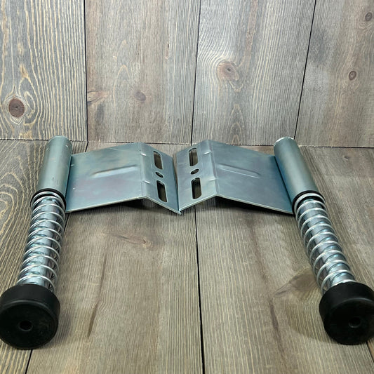 Garage door plunger bumper springs with metal plates on wooden background, part of the LAJIAOZ opener system.