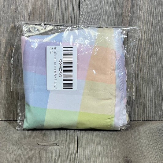 Vinyl multicolor plaid tablecloth in packaging, showcasing green, pink, blue, and yellow checks, ideal for Easter decor.