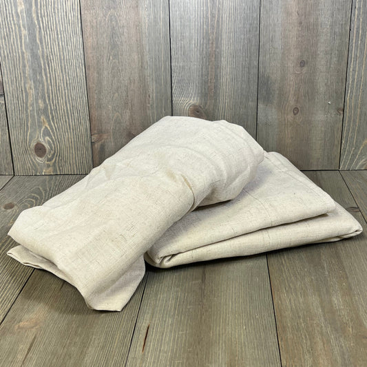 Folded H.VERSAILTEX linen curtains on wooden floor, showcasing soft, thick fabric in neutral tones, perfect for farmhouse decor.