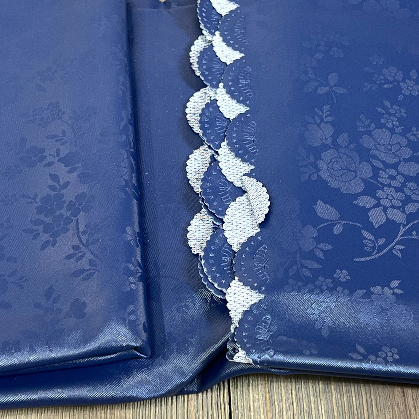 Navy blue waterproof vinyl tablecloth with floral pattern, 60x84 inches, ideal for kitchen and dining room.