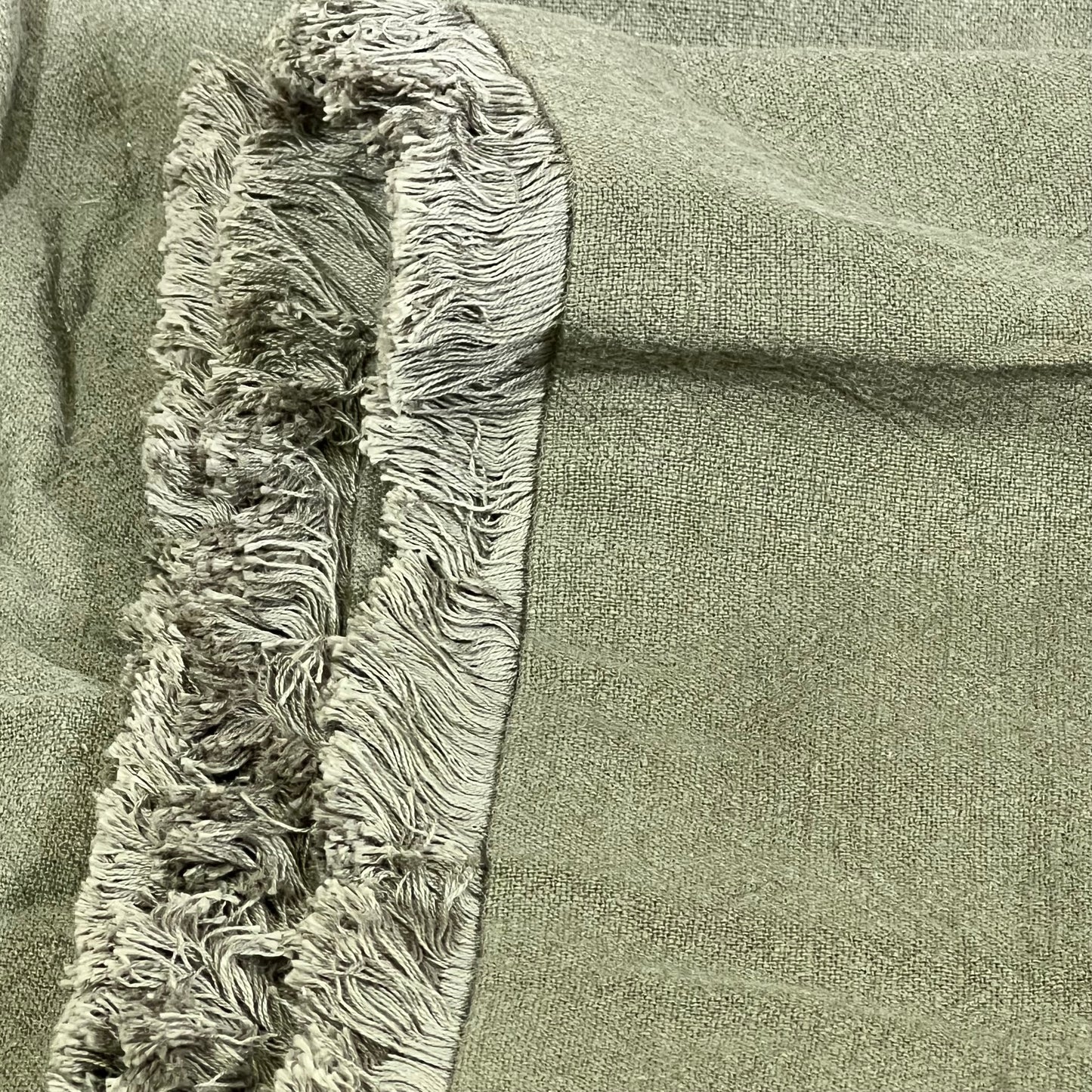 Olive green linen pillow cover with fringe detail, perfect for boho farmhouse decor in living rooms and bedrooms.