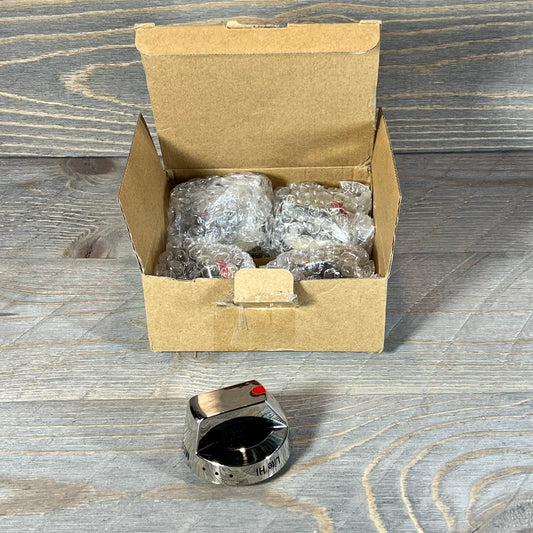 Open box with five Samsung gas stove burner control knobs wrapped in bubble wrap, one knob displayed on wooden surface.