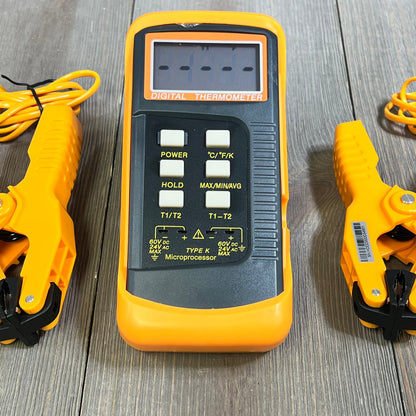 Dual-channel K Type Thermocouple Thermometer with two orange temperature clamps on a wooden surface.