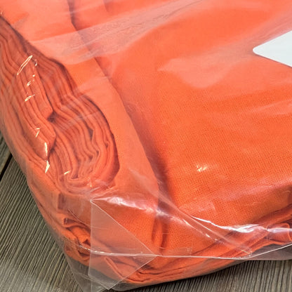 Pack of orange cotton tote bags in clear plastic, ideal for reusable shopping and DIY projects.