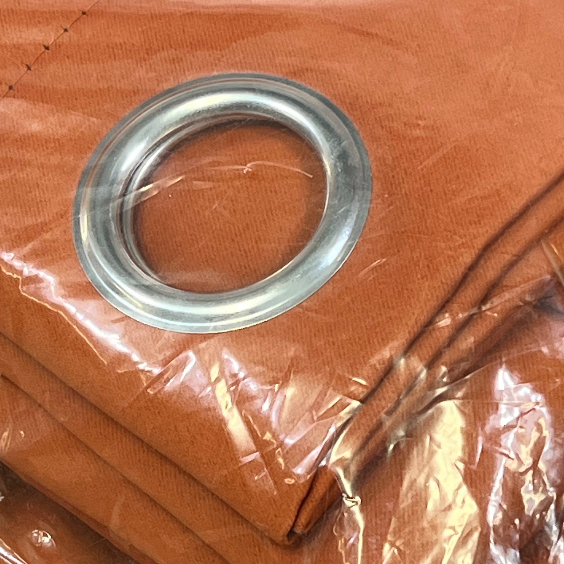 Burnt orange NICETOWN blackout curtain panel with metal grommet, showcasing heavy-duty fabric for bedroom privacy.