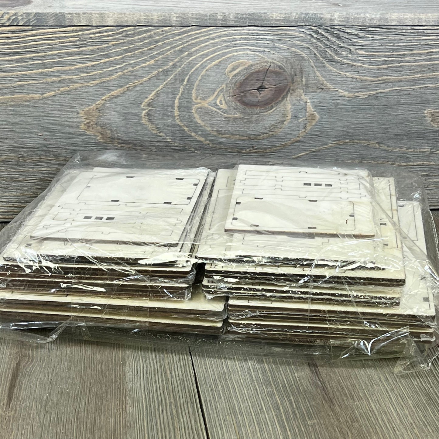 DIY Christmas Village sets packaged, showcasing wooden pieces ready for assembly into rustic church decorations.