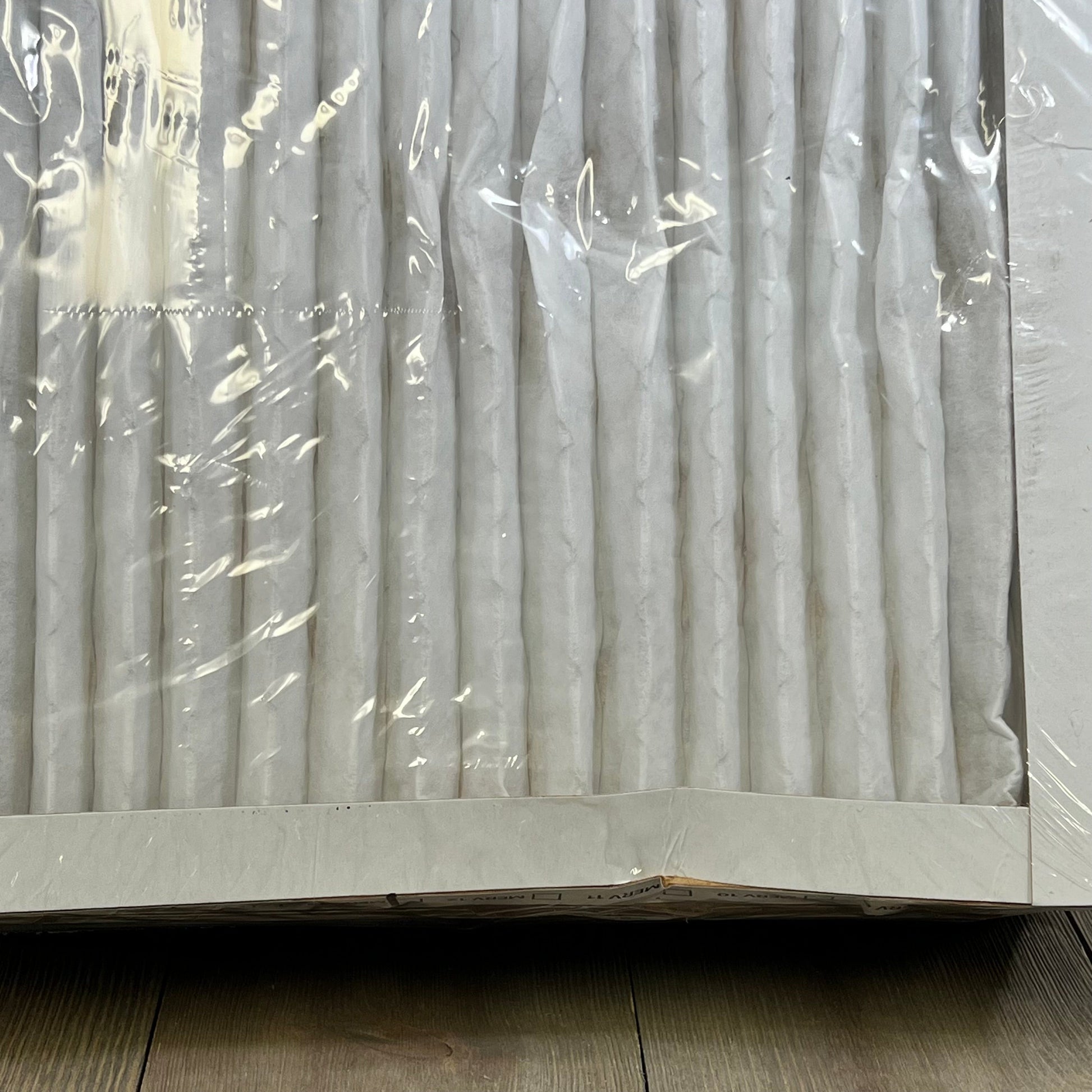 Pleated BNX TruFilter 14x14x1 Air Filter in packaging, showcasing electrostatic design and high MERV 13 efficiency.