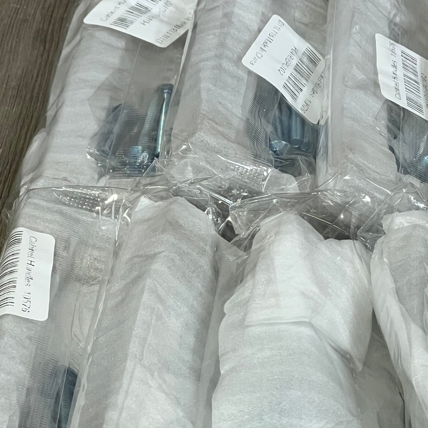 Packaged Mengico 4-inch cabinet pulls in polished chrome, ready for kitchen and bathroom installation, 10-pack set.
