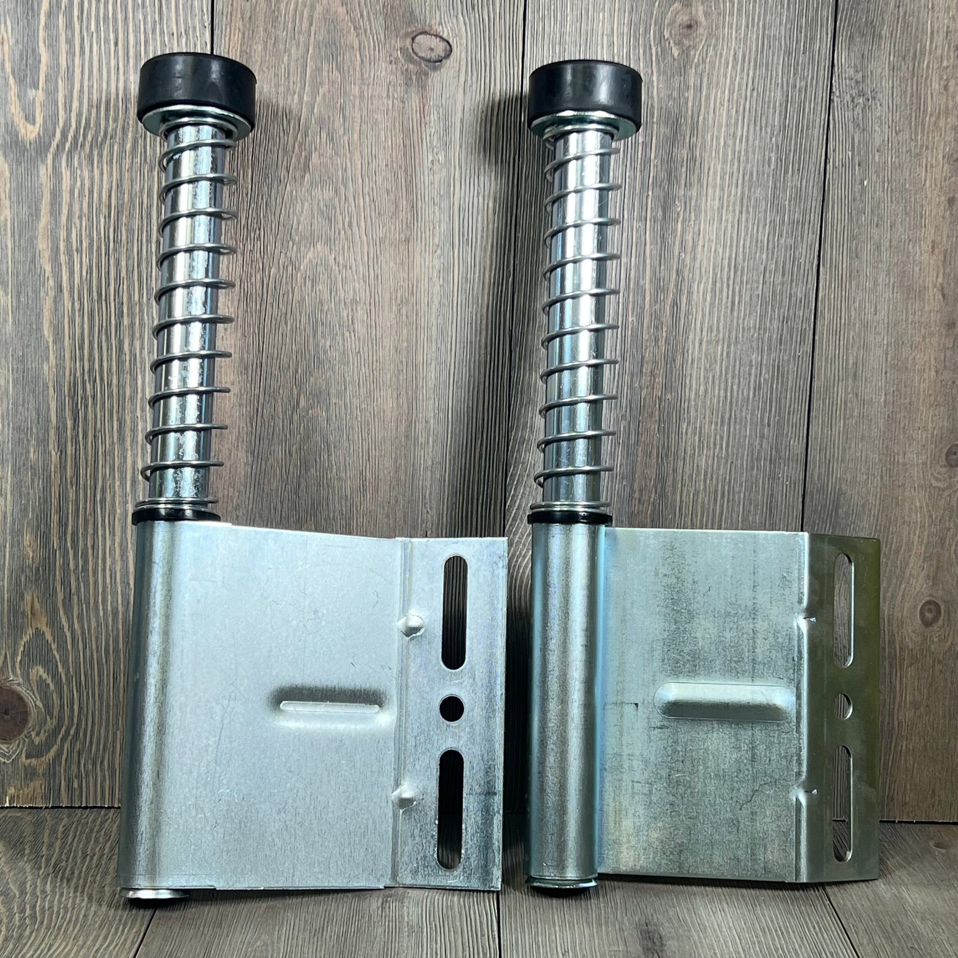 Pair of 15" garage door plunger bumpers with springs for opener systems, left and right parts, durable metal design.