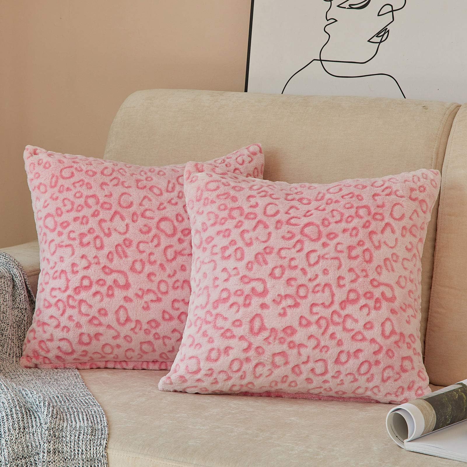 Pink leopard print pillow covers on a beige sofa, showcasing soft flannel fleece texture, perfect for couch decor.