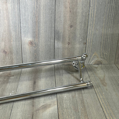 Polished Nickel Embassy double traditional towel bars on wooden background, featuring sleek design and durable craftsmanship.