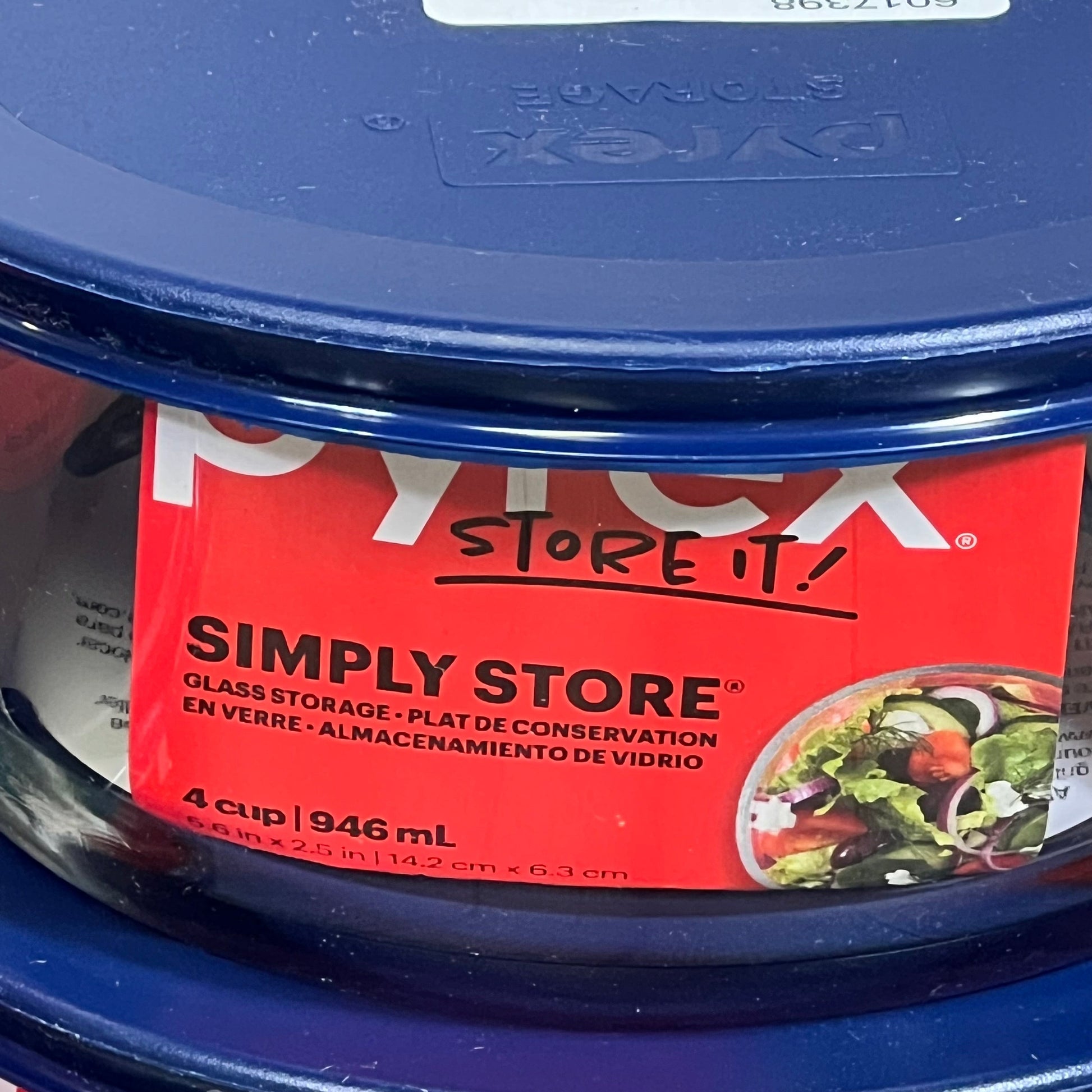 Pyrex storage container with blue lid, 4-cup capacity, featuring Simply Store branding and salad image on red label.