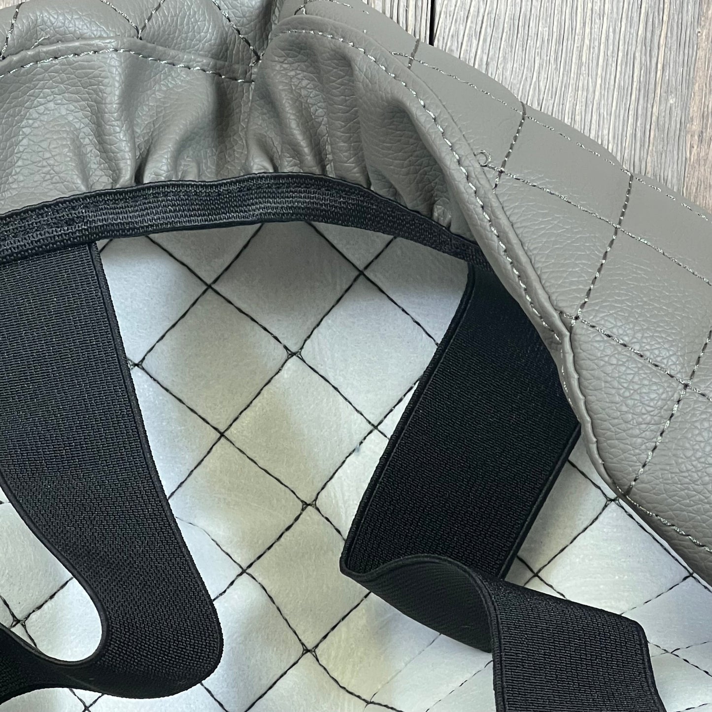 Gray leather armrest cover for Ford F250 F350 F450, featuring quilted design and elastic straps for secure fit.