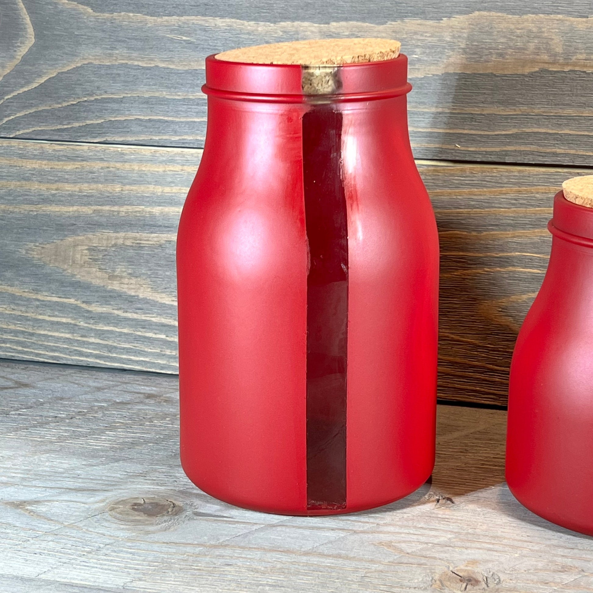 Red 68-ounce jar with cork lid and vertical window, part of French Home Set. Perfect for stylish kitchen storage.