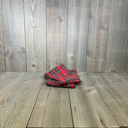 Red Scottish tartan plaid pillow covers on wooden floor, perfect for farmhouse Christmas decor.