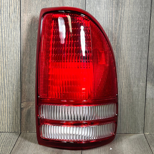 TYC Right Tail Light Assembly for 1997-2004 Dodge Dakota, showing vibrant red lens and clear sections.