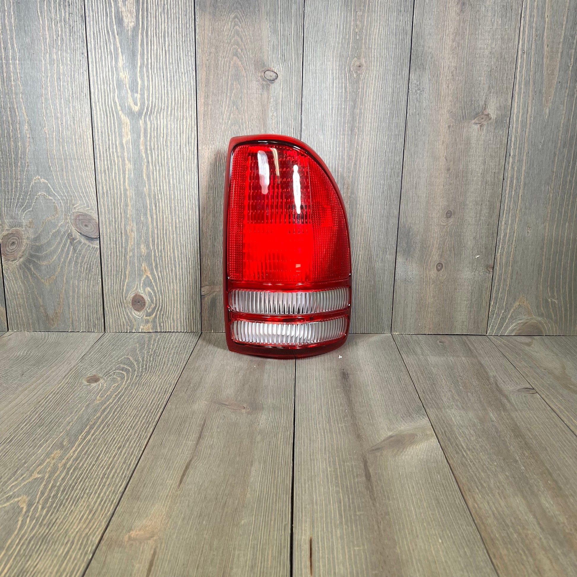 TYC right tail light assembly for 1997-2004 Dodge Dakota, featuring durable red and clear lens design.