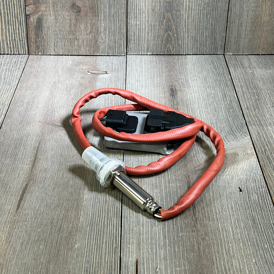 NOx sensor with red cable for BMW models, enhancing emission control. Compatible with 335d, 328d xDrive, 535d, and more.