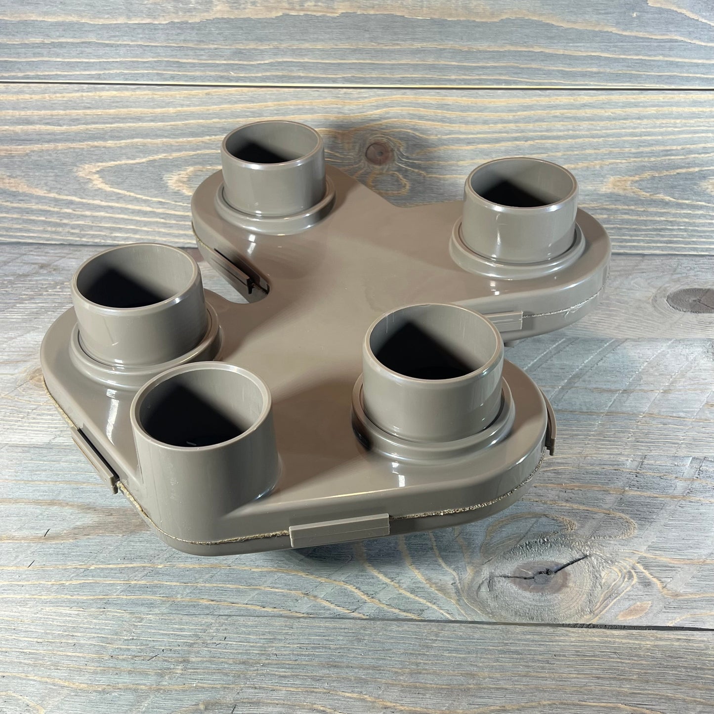 Replacement top manifold for Hayward Swim Clear filter, featuring five connection ports on a wooden background.
