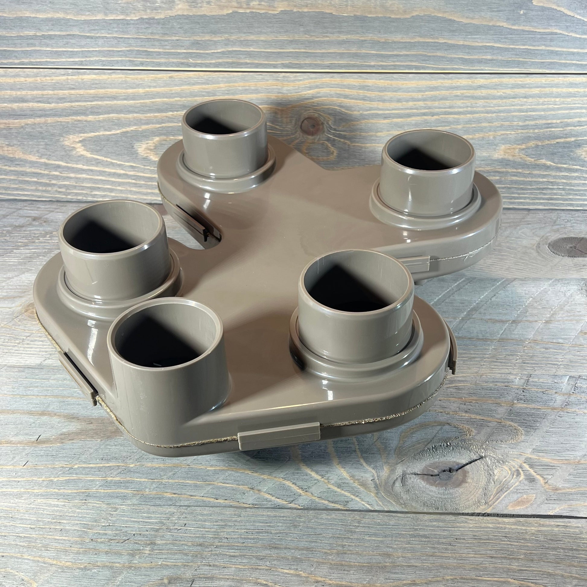 Replacement top manifold for Hayward Swim Clear filter, featuring five connection ports on a wooden background.