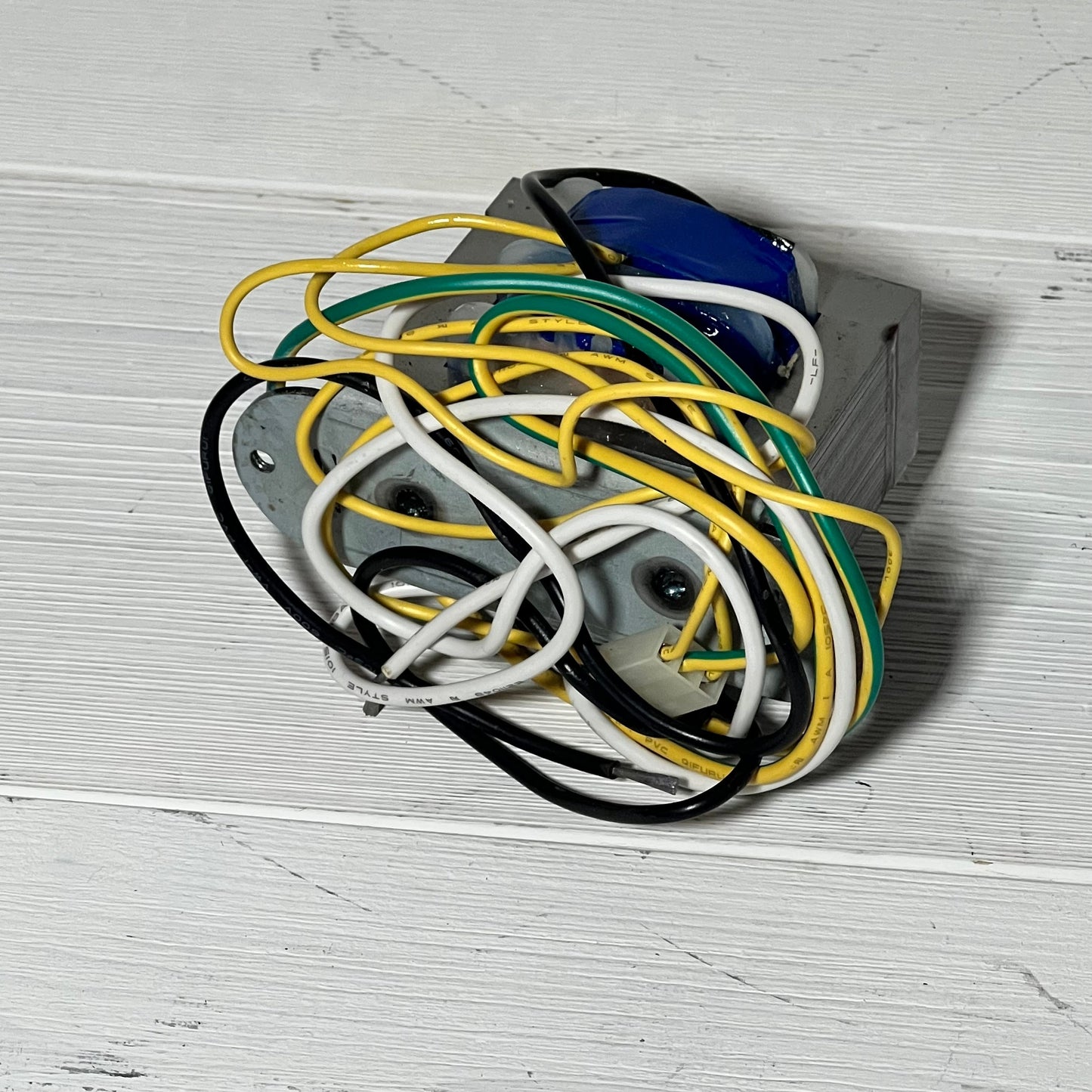 Replacement transformer for Zodiac Jandy AquaLink RS showing multiple colored wires on a white surface.