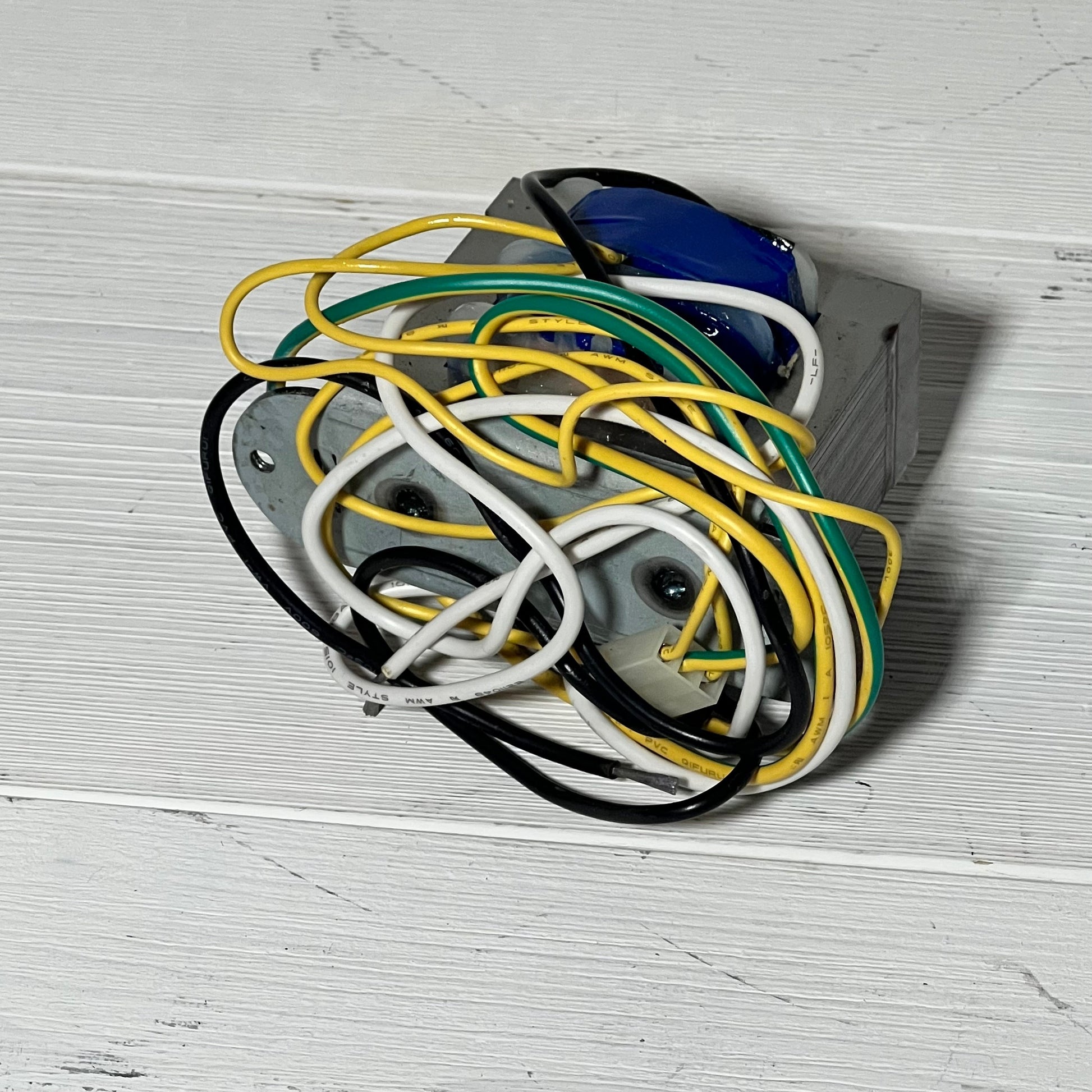 Replacement transformer for Zodiac Jandy AquaLink RS showing multiple colored wires on a white surface.