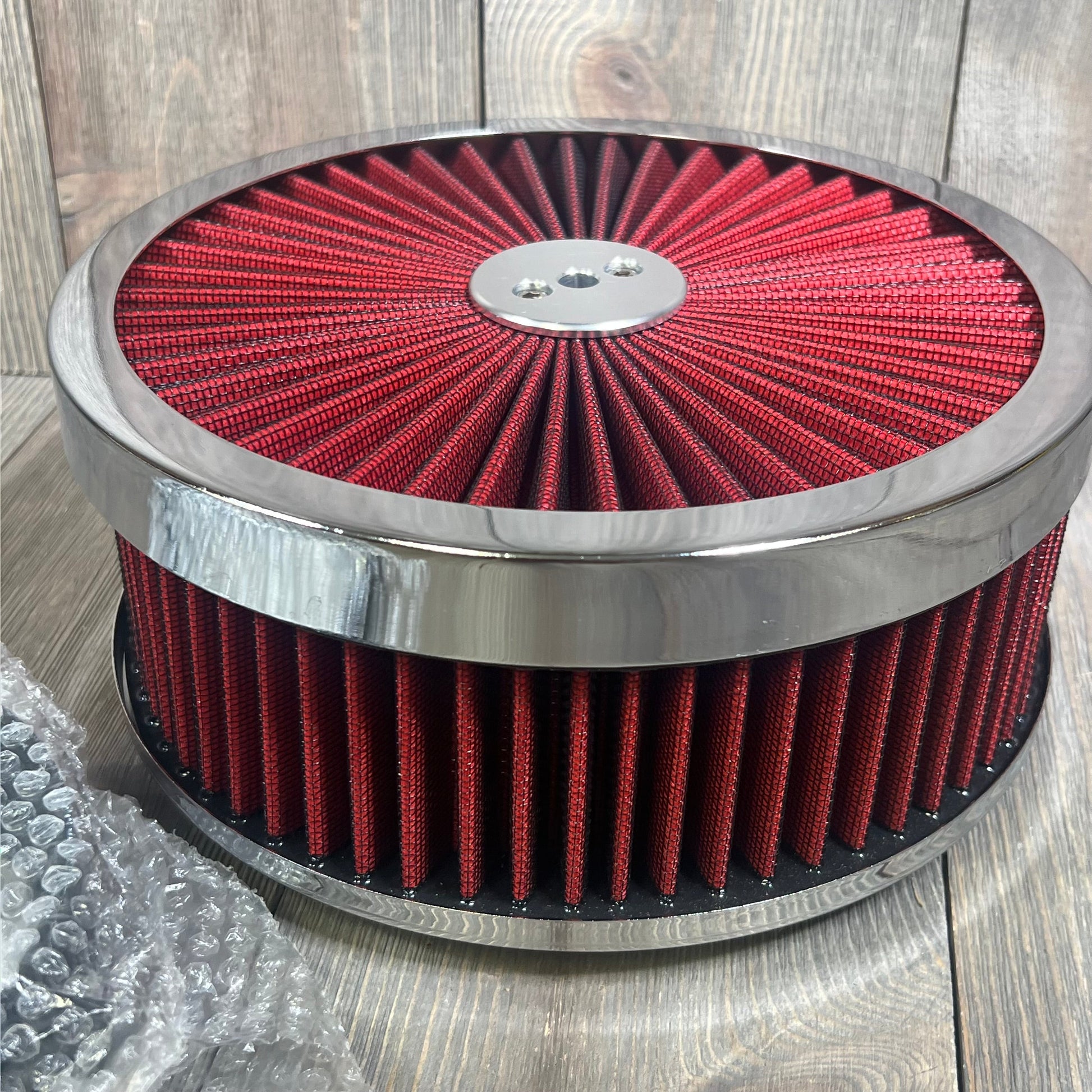 Red 9x3 inch air filter assembly with chrome trim, designed for V8 engines, featuring washable and reusable elements.