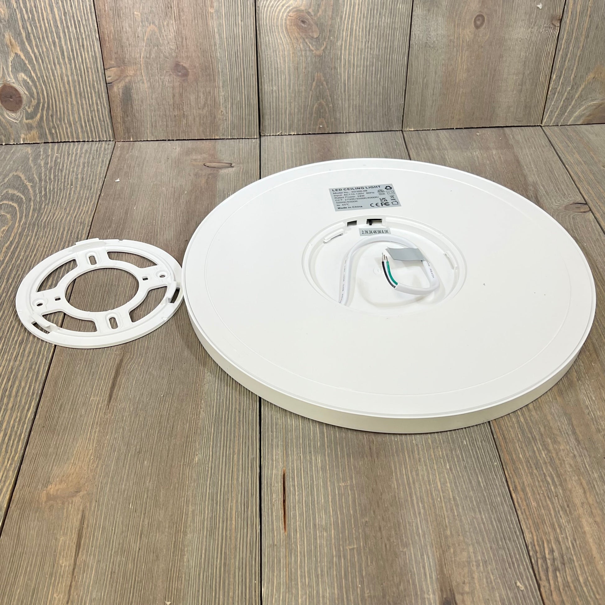 Super slim LED flush mount ceiling light fixture with mounting bracket, showcasing a sleek design and installation components.