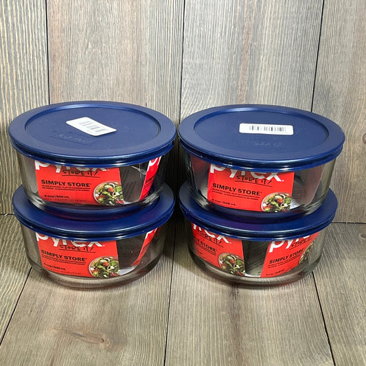 Four Pyrex 4-cup round dishes with blue lids, perfect for food storage and meal prep.