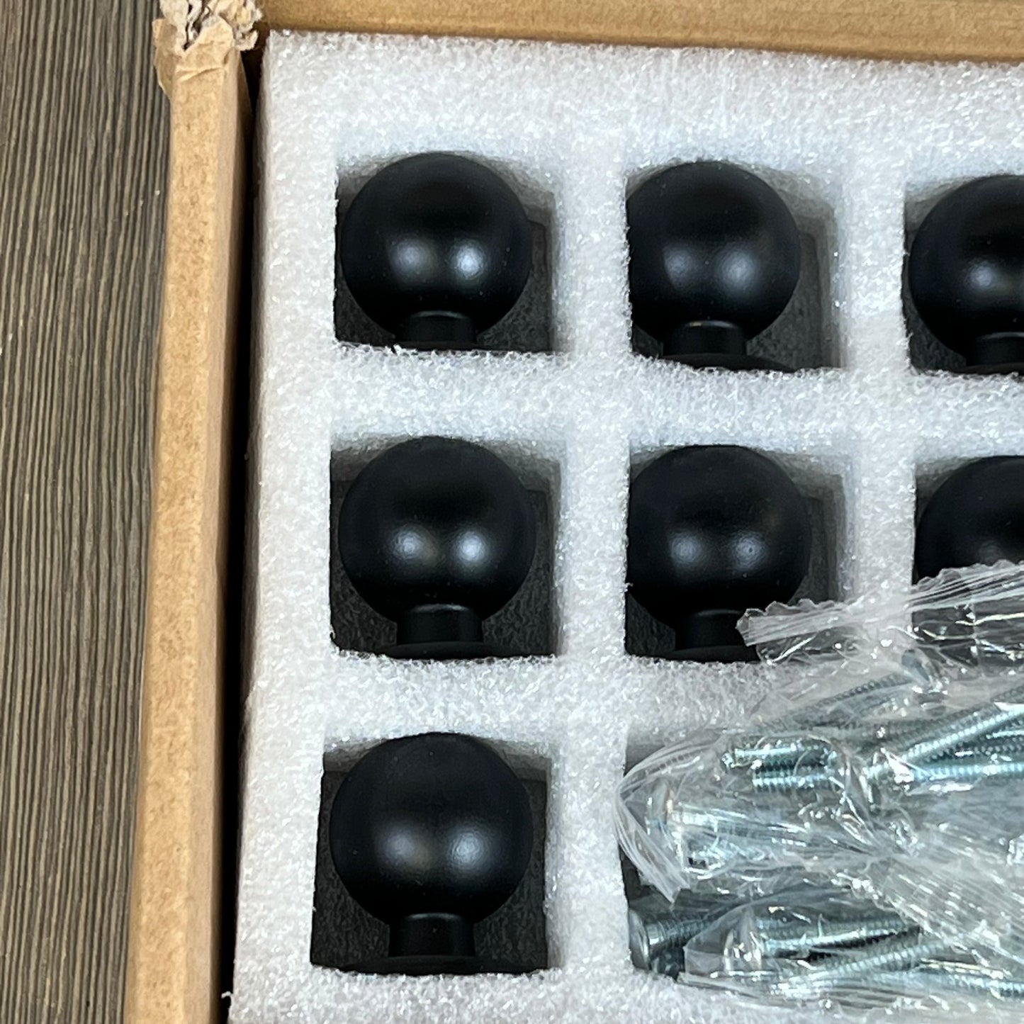 Matte black kitchen cabinet knobs in packaging, includes screws, perfect for modern dresser and drawer updates.