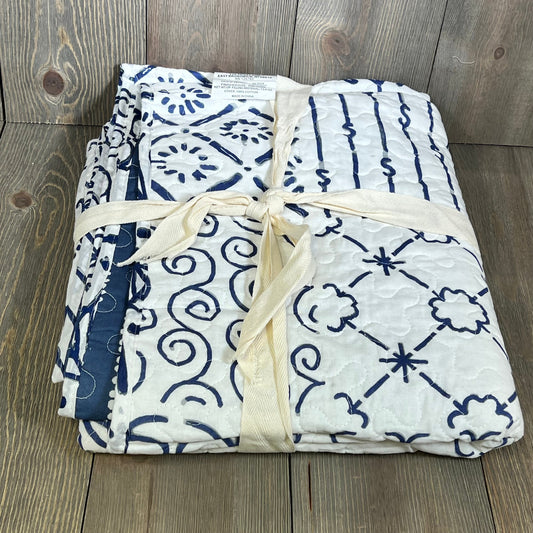 Blue and white patterned Lush Decor Monique Throw, neatly folded and tied with a cream ribbon, 50 x 60-inch size.