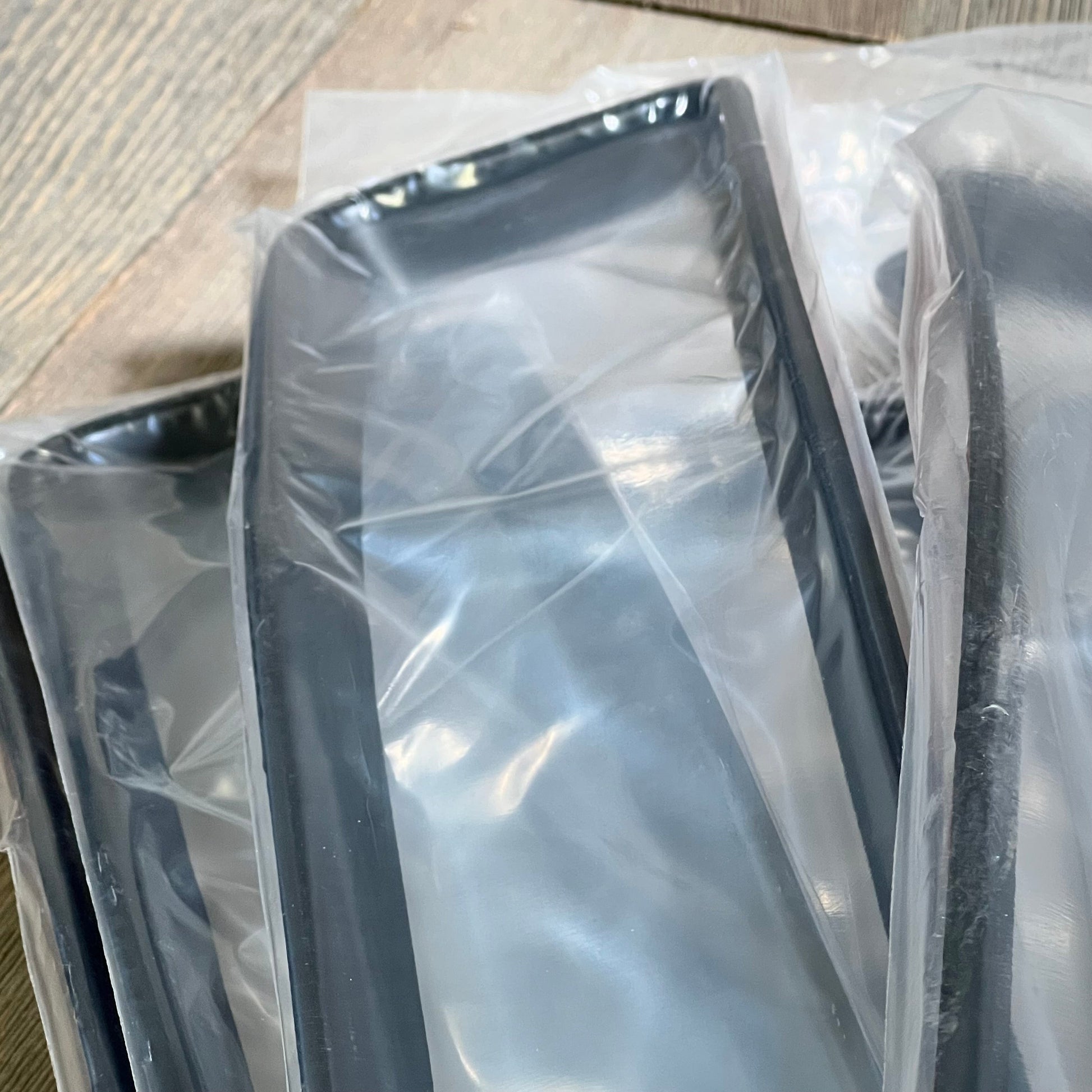 Matte black grill inserts for Jeep Wrangler 2018-2023 JL, shown packaged and ready for installation.