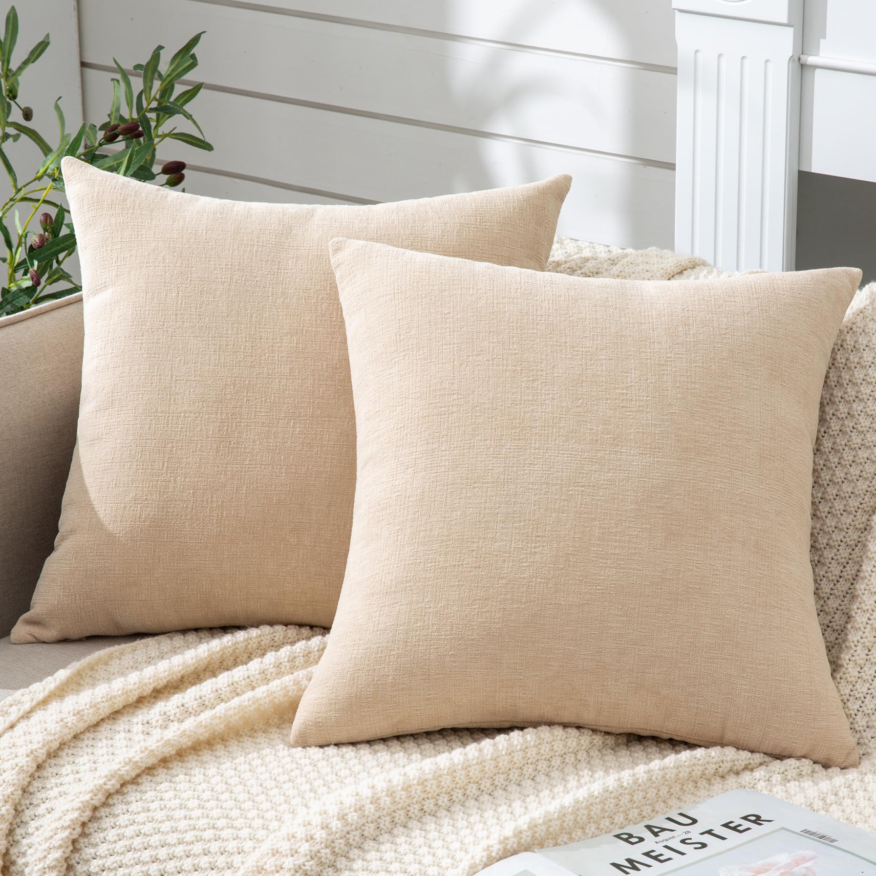 Beige chenille throw pillow covers on a cozy sofa, perfect for farmhouse decor. Set of 2, 20"x20", ideal for living room or bedroom.