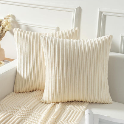 Creamy white striped corduroy velvet pillow covers on sofa, 20x20 inch, adding plush elegance to home decor.